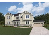 Charming two-story home with a well-manicured lawn and a three-car garage at 2541 Mabel Ln, Monroe, NC 28110