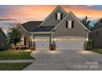 Charming home with a two-car garage, stone accents and manicured lawn at 2972 Arches Bluff Cir, Lancaster, SC 29720