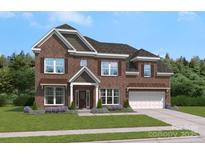 Charming brick home features a two-car garage, manicured lawn, and inviting entrance at 304 Coronado Ave, Matthews, NC 28104