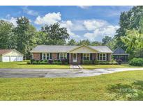 Charming brick home with black shutters, manicured landscaping, and a spacious front yard at 321 York Southern Rd, Fort Mill, SC 29715