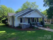 Charming home featuring a welcoming front porch with stylish brick and concrete pillars at 419 W 8Th St, Newton, NC 28658