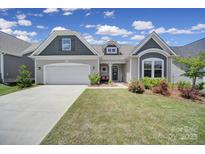 Charming one-story home with a well-manicured lawn, inviting entrance, and attached two car garage at 440 Shallowford Dr, Rock Hill, SC 29732