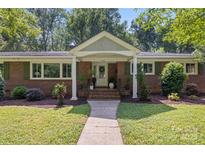 Charming brick home featuring a well-manicured lawn and inviting front entrance at 4742 Emory Ln, Charlotte, NC 28211