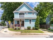 Charming two-story home featuring a covered porch and upper balcony, freshly painted in light blue at 501 Mercury St, Charlotte, NC 28205