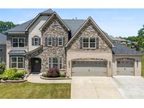 Beautiful two-story home with a stone and brick facade and a spacious three-car garage at 837 Kathy Dianne Dr, Indian Land, SC 29707