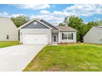 Charming single-story home with a well-manicured lawn, a two-car garage, and beautiful landscaping at 8416 Highgate Dr, Charlotte, NC 28215