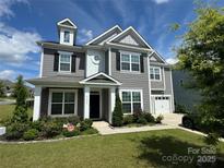 Beautiful two-story home with gray siding, a well-manicured lawn, and inviting front entrance at 8420 Golden Stone Ln # 138, Fort Mill, SC 29707