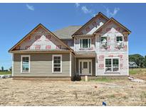 Unfinished two-story home with visible construction materials at 11555 Valley Oak Ln, Stanfield, NC 28163