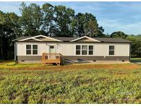 Charming single-story home with a classic design and inviting front porch at 126 Zircon Dr, Statesville, NC 28625