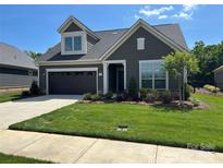 Charming home featuring manicured lawn, attached garage, and Craftsman-style detailing for a welcoming curb appeal at 1330 Millview Ln, Matthews, NC 28104