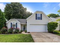 Charming single-Gathering home with a two-car garage, well-manicured lawn and beautiful landscaping at 1445 Deer Forest Dr, Indian Land, SC 29707