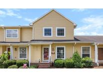 Charming yellow two-story home with well-maintained landscaping and a welcoming front porch at 1670 Robins Nest Ct # C, Gastonia, NC 28054