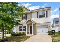 Two-story home with beige siding, black shutters, and a well-manicured front yard at 2005 Amos Oaks Ln, Charlotte, NC 28215