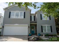 Charming two-story home with a bright teal front door, black shutters, and attached garage at 2090 Durand Rd, Fort Mill, SC 29715