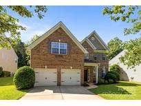 Charming brick home with a two-car garage, well-manicured lawn, and lovely landscaping at 3006 S Legacy Park Blvd, Indian Land, SC 29707