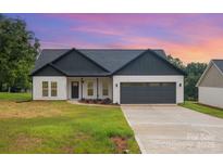 Charming one-story home featuring a gray roof, attached two-car garage, and a well-manicured lawn at 3486 Winters St, Newton, NC 28658