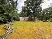Cozy home with a charming covered porch and a large yard surrounded by mature trees at 370 Miracle Dr, Salisbury, NC 28146