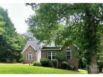 Charming brick home with well-manicured lawn and green shutters at 613 Stacy Ridge Rd, Gastonia, NC 28052