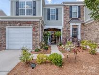 Beautiful exterior with brick and siding, lush landscaping, and a welcoming front entrance at 739 Elders Story Rd, Fort Mill, SC 29708