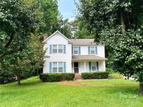 Charming two-story home features a classic design with bright shutters and a well-manicured lawn at 9701 Kent Village Dr, Charlotte, NC 28269
