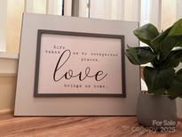 A decorative sign reads, 