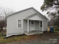 Charming single-story home with a covered front porch and light gray vinyl siding at 1110 20Th Ne St, Hickory, NC 28601