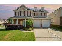 Charming two-story home with a well-manicured lawn, brick accents, and a two-car garage, offering great curb appeal at 124 Glade Valley Ave, Mooresville, NC 28117