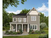 Charming two-story home featuring gray siding, a welcoming front porch, and professionally landscaped yard at 19036 Newburg Hill Rd, Davidson, NC 28036