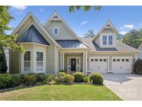 Charming two-story home with a manicured lawn, colorful landscaping, and a two-car garage at 196 Hawks Creek Pkwy, Fort Mill, SC 29708