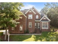 Charming brick home with a well-manicured lawn and inviting entrance perfect for a Gathering at 2019 Lynmore Dr, Sherrills Ford, NC 28673