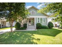 Charming home with a well-manicured lawn, lush landscaping, and a welcoming front porch, perfect for relaxation at 232 Orange St, Charlotte, NC 28205