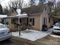 Charming single-Gathering home showcasing a quaint covered porch and a traditional architectural style in a winter setting at 2942 Reid Ave, Charlotte, NC 28208