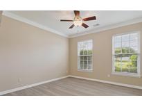 Spacious bedroom with a ceiling fan, neutral paint, and large windows providing natural light at 3043 Streamlet Way, Monroe, NC 28110