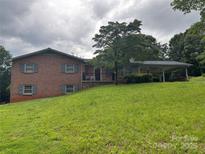 Charming two-story brick home featuring a spacious lawn and carport at 356 Lucky Hollow Rd, Hickory, NC 28601
