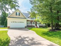 Inviting traditional home with a two-car garage, covered front porch, manicured lawn and mature landscaping at 3697 Travertine Dr, Lancaster, SC 29720