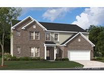 Inviting two-story home with a brick facade, attached garage, manicured lawn, and classic architectural details at 416 Balboa St, Matthews, NC 28104