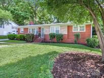 Charming brick home featuring a well-maintained lawn and mature landscaping at 6401 Montpelier Rd, Charlotte, NC 28210