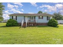 Charming single-story home with a welcoming front porch and landscaped yard, perfect for suburban living at 7785 Crestwood Dr, Kannapolis, NC 28081