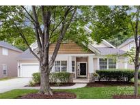 Charming exterior view of a single-Gathering home with a well-manicured lawn and inviting front porch at 1040 Stonedown Ln, Matthews, NC 28104