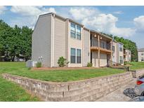 Inviting townhouse featuring a balcony, manicured lawn, and ample parking in a desirable neighborhood at 11069 Running Ridge Rd, Charlotte, NC 28226
