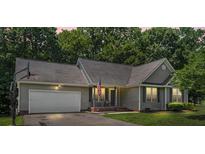 Charming single-story home with gray siding, well-manicured lawn, and inviting front porch at 124 Turning Leaf Ln, Statesville, NC 28677