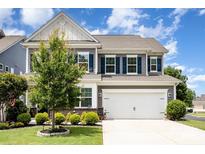 Charming two-story home featuring a well-maintained lawn, blue shutters, and an attached two-car garage at 126 W Morehouse Ave, Mooresville, NC 28117