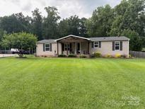 Charming single-story home featuring a cozy front porch and a well-maintained lawn at 1489 L R Schronce Ln, Iron Station, NC 28080