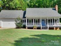 Charming home featuring a cozy front porch, attached garage, and well-maintained lawn at 1529 Covenant Pl, Rock Hill, SC 29732