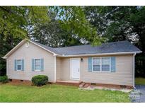 Charming single-story home featuring light siding, blue shutters, and a well-maintained lawn at 201 Killian Cir, Clover, SC 29710