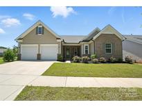 Charming home featuring a manicured lawn, a two-car garage, and a welcoming front entrance at 231 Cotton Ridge Pl, Rock Hill, SC 29730