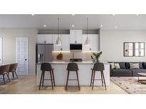 Modern kitchen with white cabinets, stainless steel appliances, and a large island at 4059 Bass River Pkwy, Charlotte, NC 28217