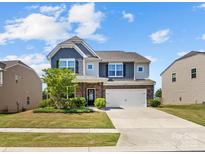 Charming two-story home with a well-manicured lawn and attached two-car garage at 4261 Coachwhip Ave, Lancaster, SC 29720