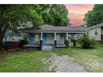 Charming single-story home showcasing a welcoming front porch and a well-maintained lawn at 4510 Wildwood Ave, Charlotte, NC 28208