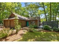 Charming single-story home featuring mature landscaping, a brick facade, and a cozy front porch at 498 Glory Ct, Fort Mill, SC 29715